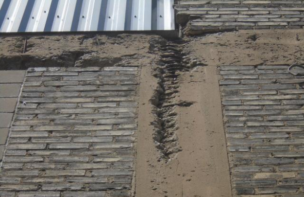 The cement columns with brick in-fill have eroded and allows water directly into the interior.